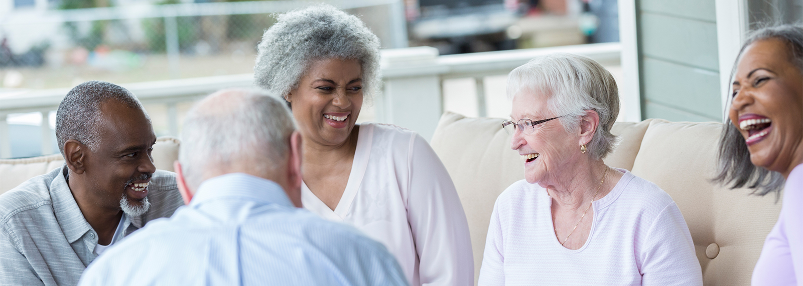Group of seniors on porch talking